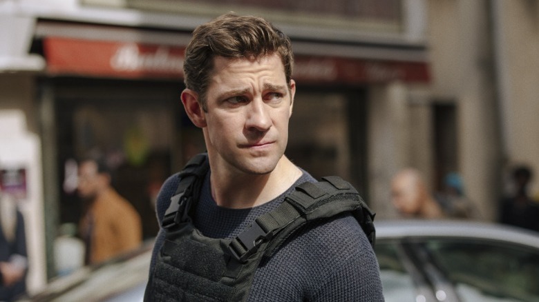 John Krasinski stands on a street as Jack Ryan