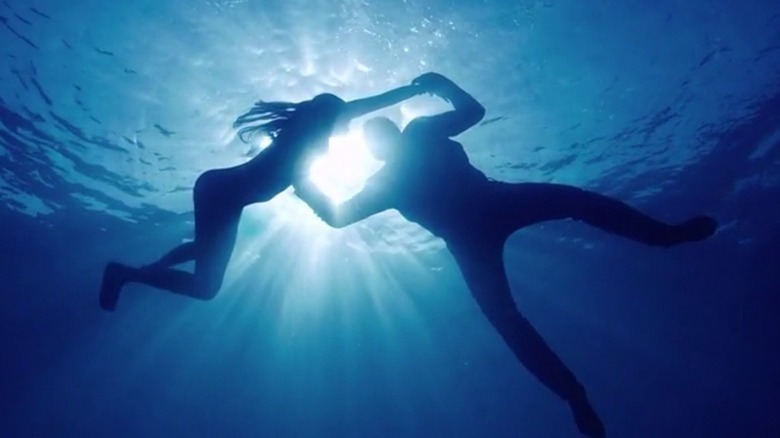 Two silhouettes in water