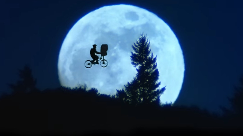 E.T. flies in front of the moon