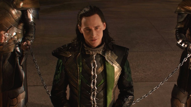 Loki standing in chains