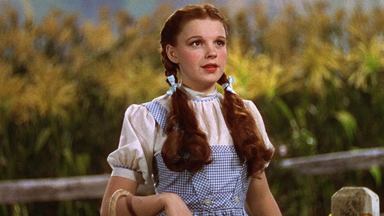 Dorothy looks up in corn field