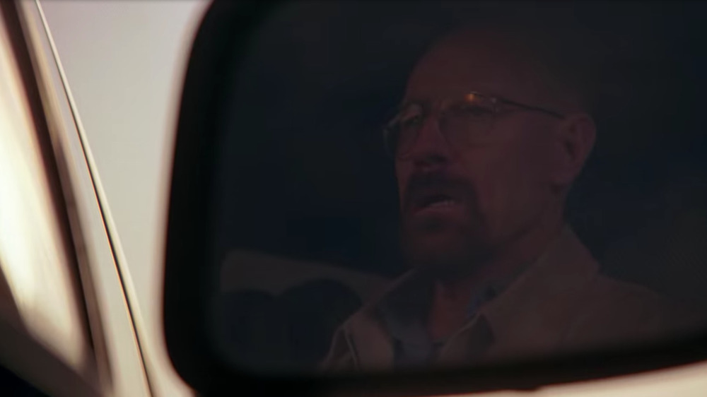 Walter White's reflection in a car window