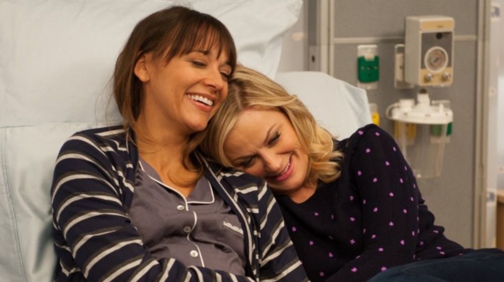 Ann and Leslie embracing on hospital bed