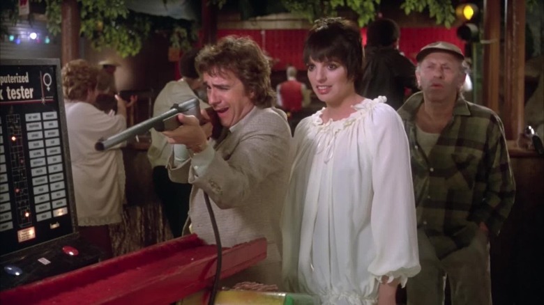 Dudley Moore and Lisa Minelli shooting guns