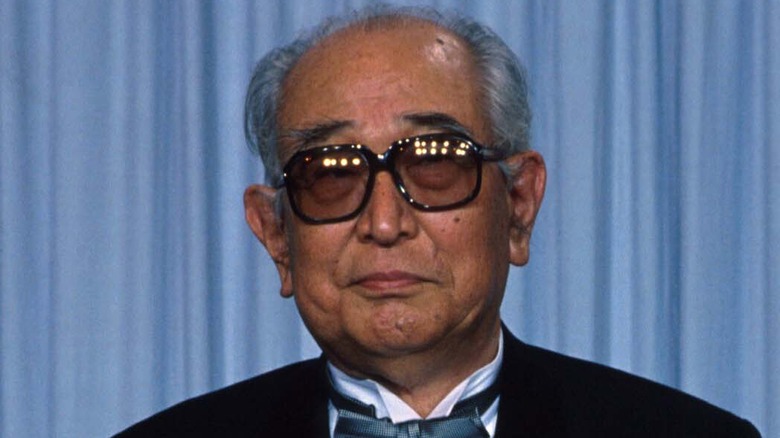 Akira Kurosawa waits in sunglasses and tuxedo in 1990