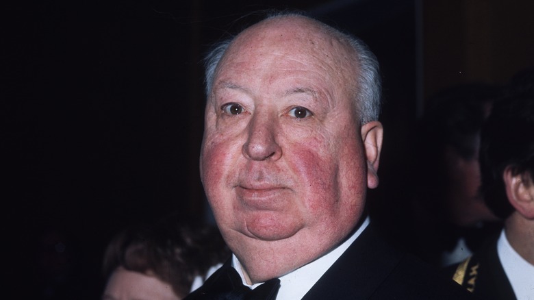 Alfred Hitchcock peers in tuxedo in 1971