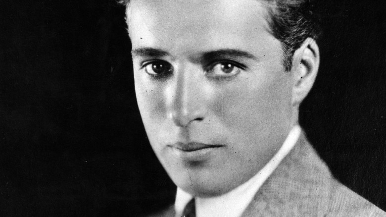 Charlie Chaplin smiles in black and white portrait in 1929