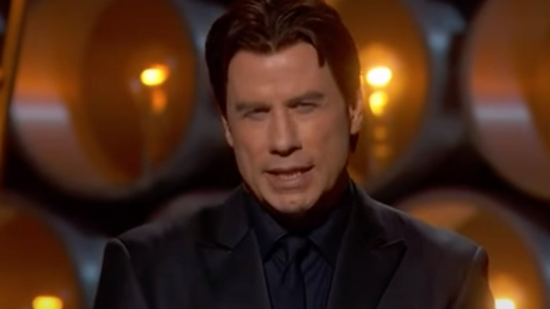 John Travolta trips himself up