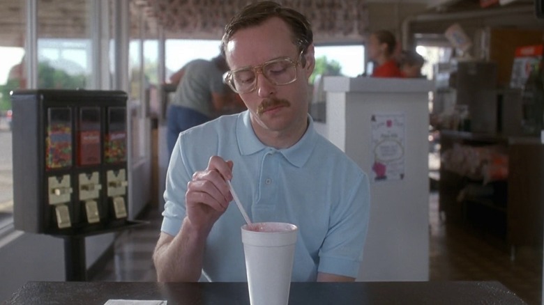 Aaron Ruell stirs straw in drink