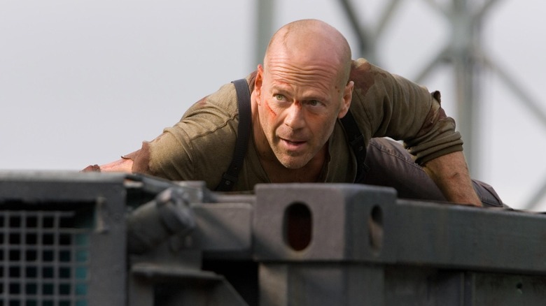 Bruce Willis rides on car