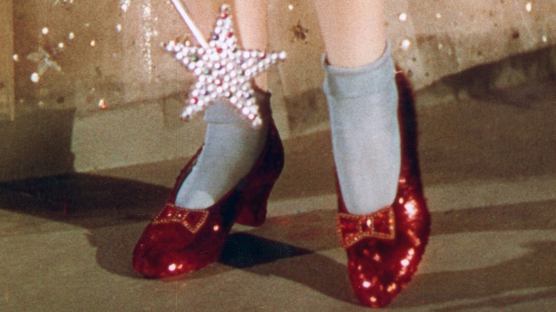 Dorothy tries on the ruby slippers