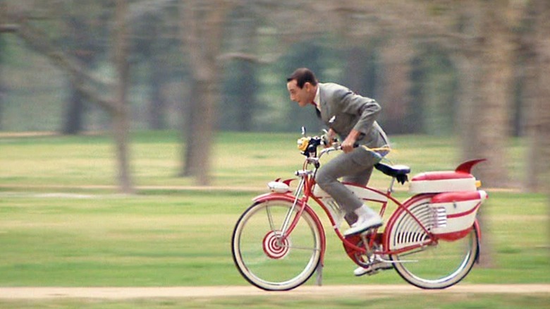 Pee Wee rides his bike