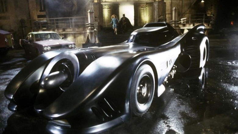 Batman and Vicki run to Batmobile