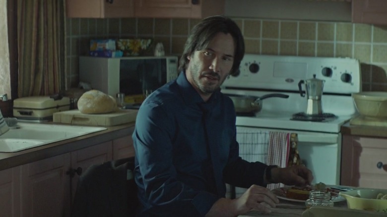 Keanu Reeves sitting at dining room table