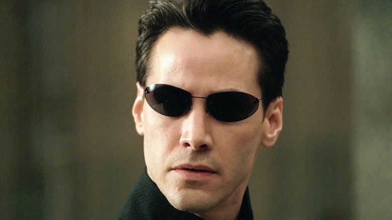 Neo wearing black glasses