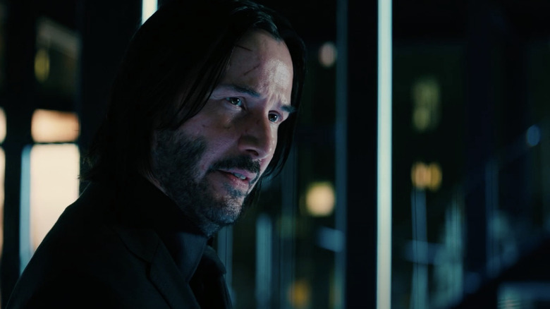 John Wick with cuts on face