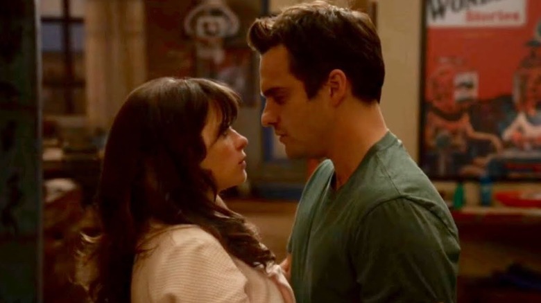 Zoeey Deschanel and Jake Johnson embracing