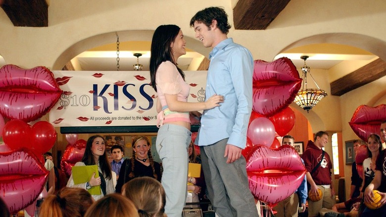 Rachel Bilson and Adam Brody standing on a coffee cart