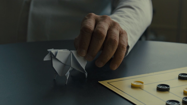hand holds origami sheep