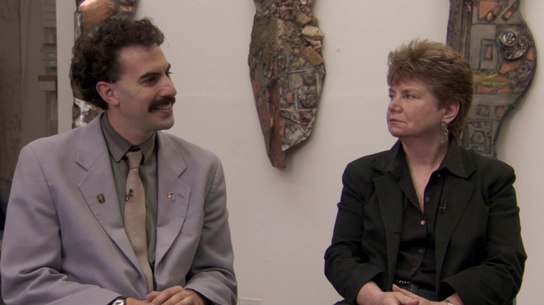 Borat smiling with a woman