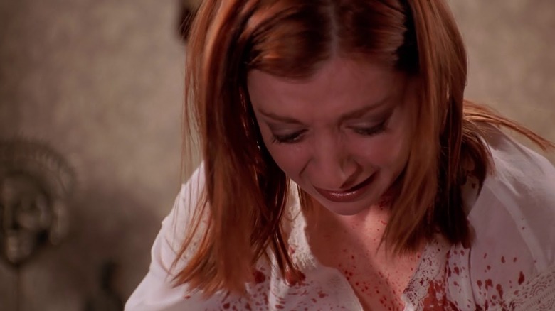 Willow looking distraught with Tara's blood on shirt