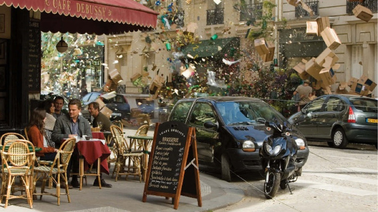 Cobb and Ariadne sitting in Paris cafe