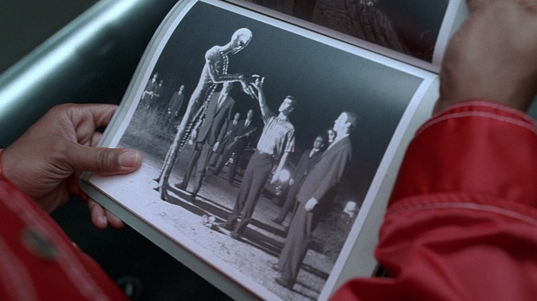 Edwards holds picture of alien encounter