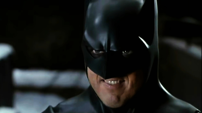 Batman smirks at a goon who is about to explode