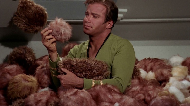 Kirk covered in tiny, furry creatures