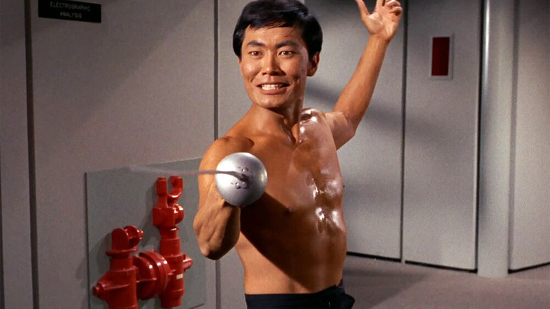 Sulu smiles while brandishing fencing sword