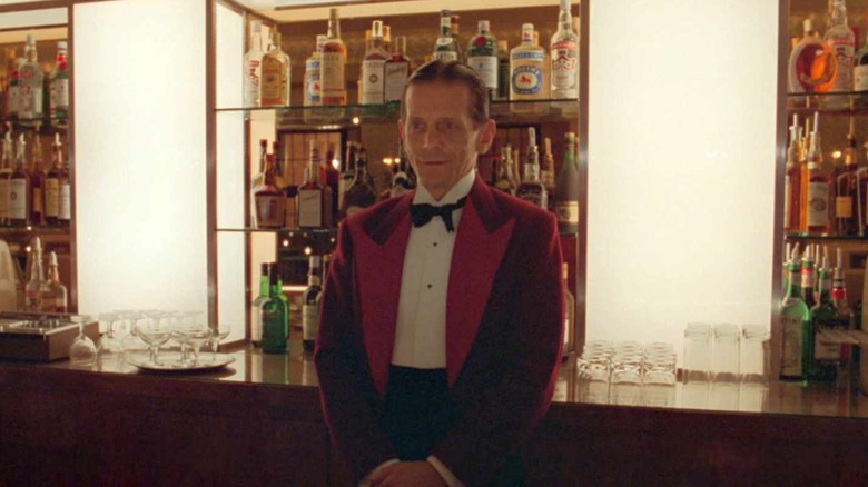 a bartender stands at attention