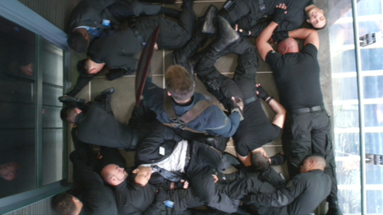 Captain America stands over the fallen Hydra agents in the elevator in "Captain America: The Winter Soldier."