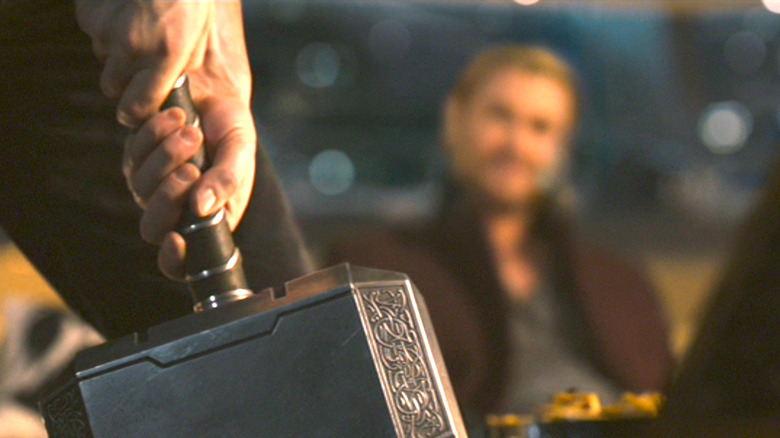 Steve Rogers moves Thor's hammer during the after party scene in "Avengers: Age of Ultron."