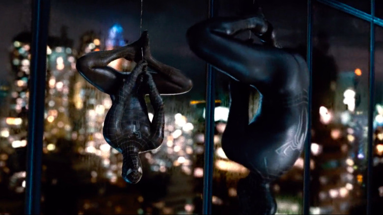 Black suit Spider-Man hanging upside down