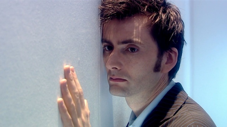 David Tennant pressed against a wall longingly