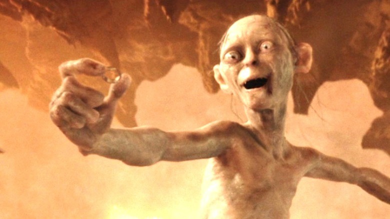 Gollum holds the Ring in triumph