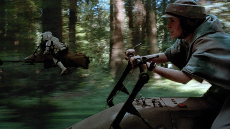 Leia and a stormtrooper on speeder bikes