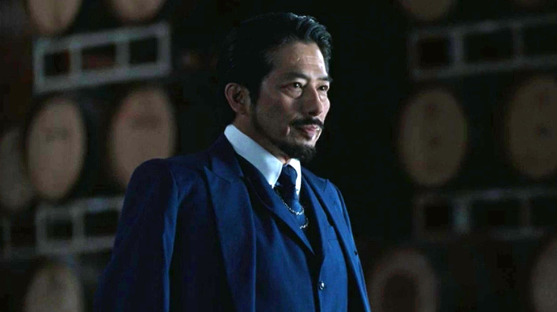 Musashi host wearing suit