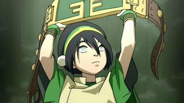 Toph with her Earthbending Champion Belt