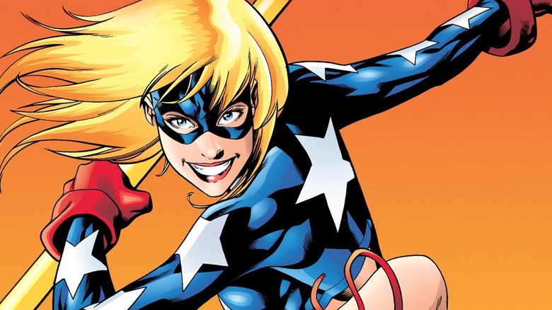 Courtney Whitmore as Star Girl smiling and holding her Cosmic Staff