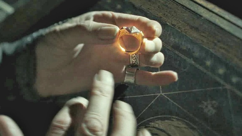 Albus Dumbledore examines Tom Gaunt's ring