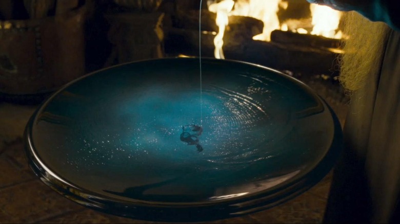 Albus Dumbledore pouring a memory into a Pensieve