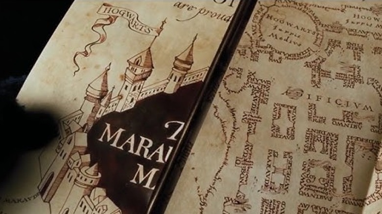 Harry holding the Marauder's Map after Fred and George give it to him