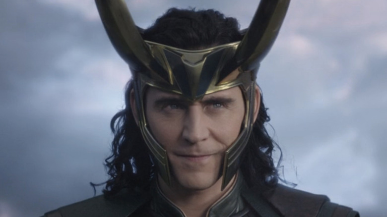 Loki smirking wearing his helmet