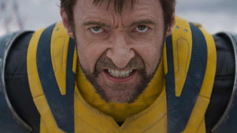 Wolverine wearing his iconic yellow suit and sneering angrily in Deadpool & Wolverine