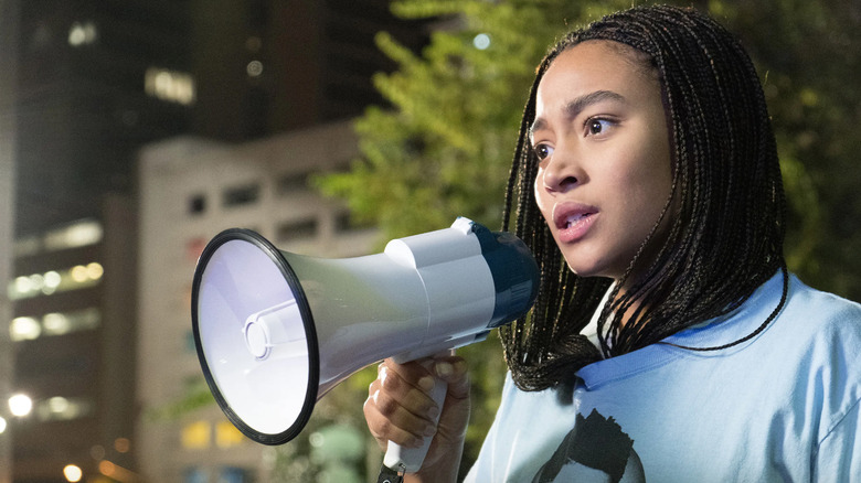 Starr holding a megaphone