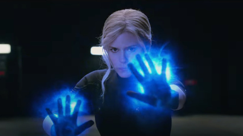 Kate Mara as the Invisible Woman with hands up