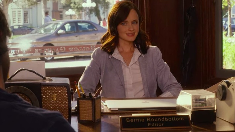 Rory sits at her desk 