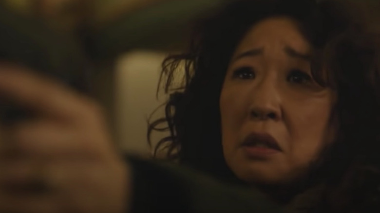 Sandra Oh points a gun