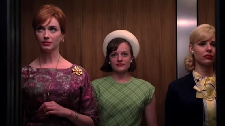 Joan, Peggy, and Fay stand in elevator 